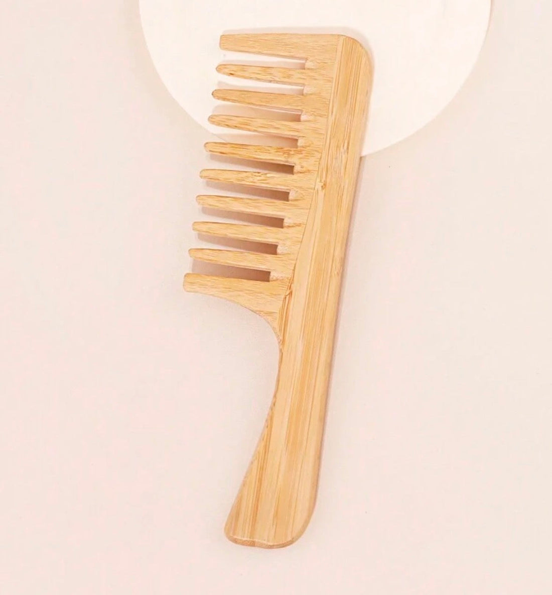 Introducing our Bamboo Wooden Comb, where beauty meets sustainability.